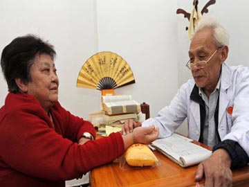 Chinese Doctor diagnose the patient by feeling pulse